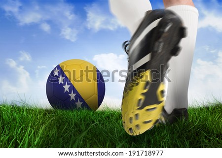 Composite image of football boot kicking bosnia ball against field of grass under blue sky