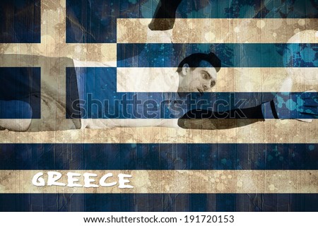 Goalkeeper in white making a save against greece flag in grunge effect