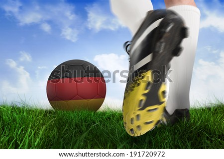 Composite image of football boot kicking belgium ball against field of grass under blue sky