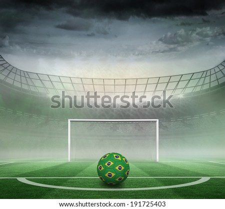 Football in brazilian colours against football pitch in large stadium