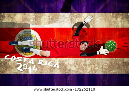 Goalkeeper in red making a save against costa rica flag in grunge effect