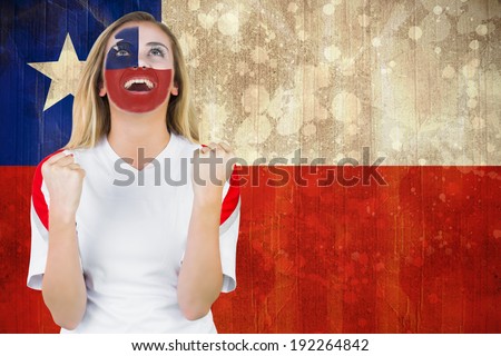 Excited chile fan in face paint cheering against chile flag in grunge effect