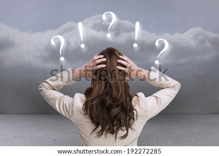 Young classy businesswoman with hands on head standing back to camera against clouds in a room