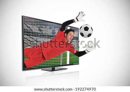 Composite image of fit goal keeper saving goal through tv against white background with vignette