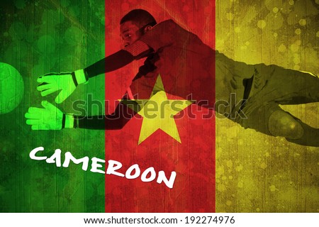 Goalkeeper in green making a save against cameroon flag in grunge effect