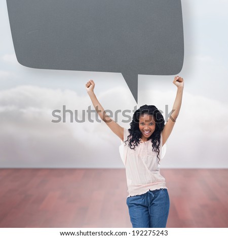 A young happy woman with speech bubble against clouds in a room