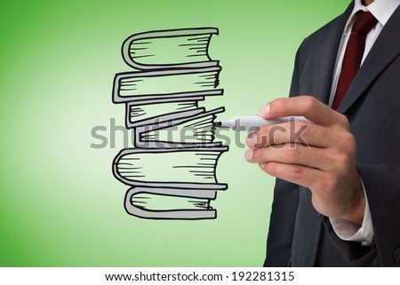 Composite image of businessman drawing books against green vignette