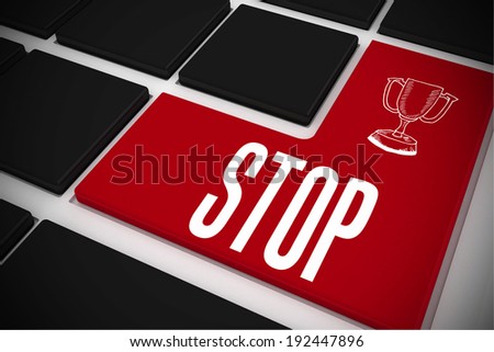 The word stop and winners cup on black keyboard with red key