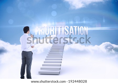 The word prioritisation and businessman holding glasses against shut door at top of stairs in the sky