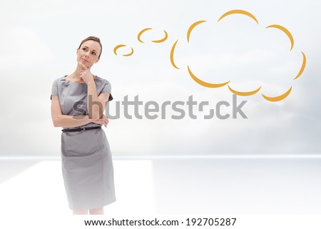 Thoughtful woman posing in dress with thought bubble against clouds in a room