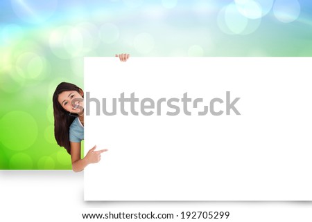 Composite image of pretty brunette showing white card