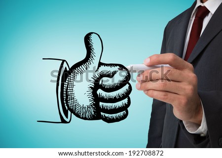 Composite image of businessman drawing thumbs up against blue vignette