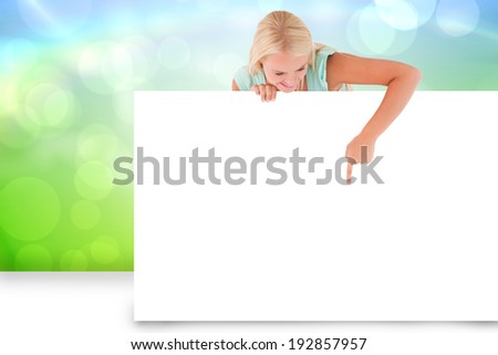 Composite image of pretty blonde showing white card