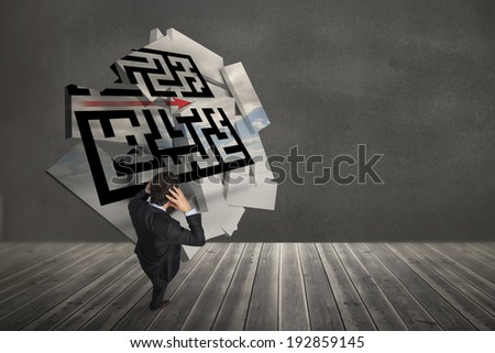 Stressed businessman with hands on head against maze graphic on abstract screen in room