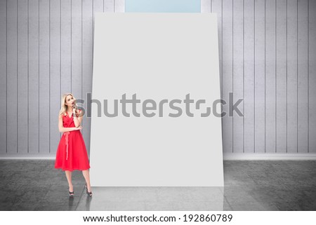 Composite image of thoughtful blonde wearing red dress against white card