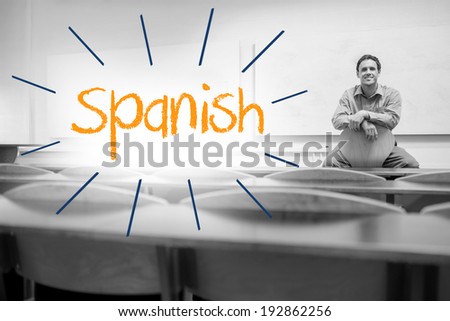 The word spanish against lecturer sitting in lecture hall
