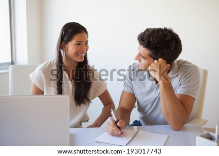 Casual business team working together at desk in the office
