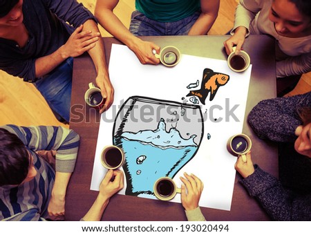 Goldfish jumping from light bulb bowl against people sitting around table drinking coffee