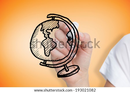 Composite image of businesswoman drawing globe against orange vignette