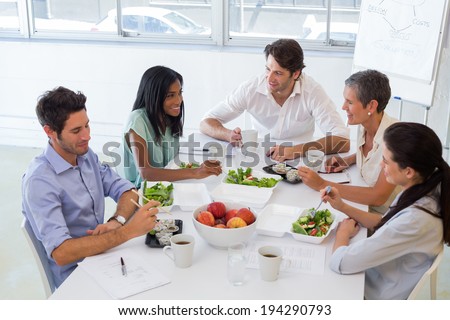 Business people eating lunch together in the office