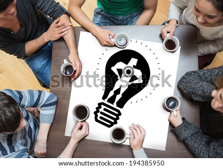 People sitting around table drinking coffee with page showing idea and innovation graphic