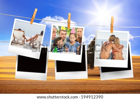 Composite image of instant photos hanging on a line against field and blue sky