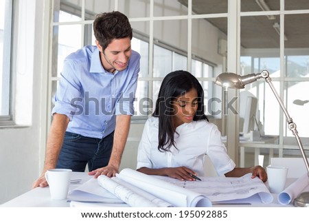 Architects working on important blueprints in the office