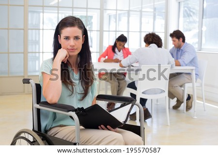 Attractive disabled businesswoman at work smiling at the camera