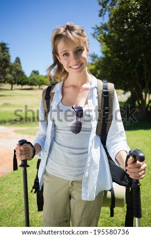 Fit smiling woman going for a hike on a sunny day