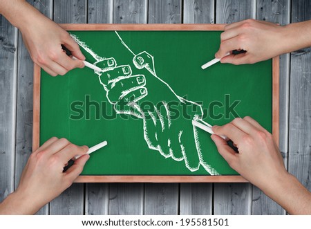 Composite image of multiple hands drawing handshake with chalk on wooden board