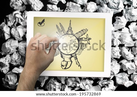 Composite image of hand touching tablet showing landmarks around the world