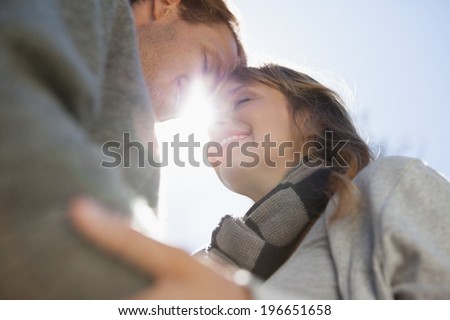Cute couple hugging in the park on a sunny day