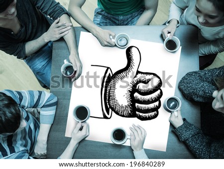 People sitting around table drinking coffee with page showing thumbs up