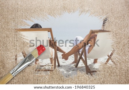 Composite image of couple on the beach in deck chairs with paintbrush dipped in red against weathered surface