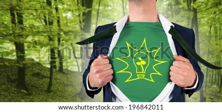 Businessman opening shirt in superhero style against peaceful green forest