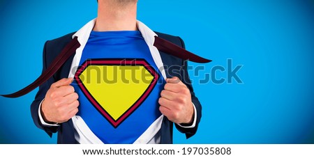 Businessman opening shirt in superhero style against blue background with vignette