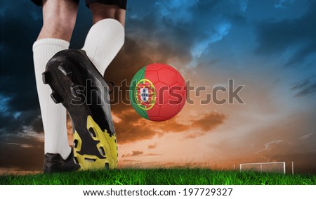 Composite image of football boot kicking spain ball against green grass under blue and orange sky