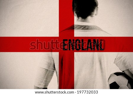 England football player holding ball against england national flag
