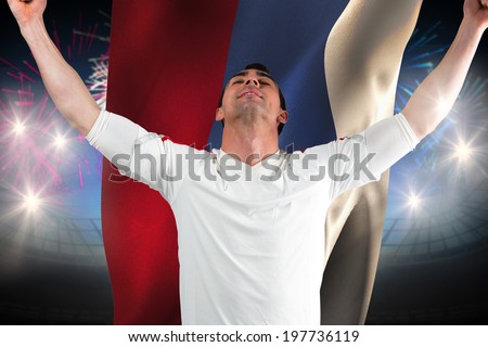 Excited football fan cheering against fireworks exploding over football stadium and russia flag