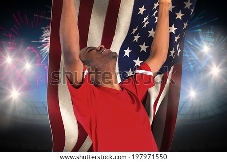 Excited handsome football fan cheering against fireworks exploding over football stadium and usa flag