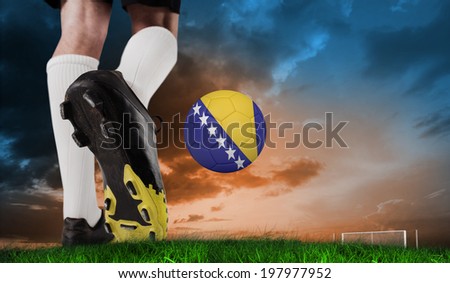 Composite image of football boot kicking bosnia ball against green grass under blue and orange sky