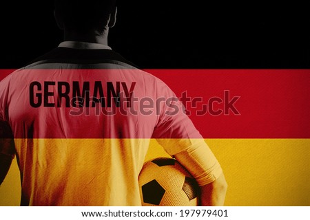 Germany football player holding ball against germany national flag