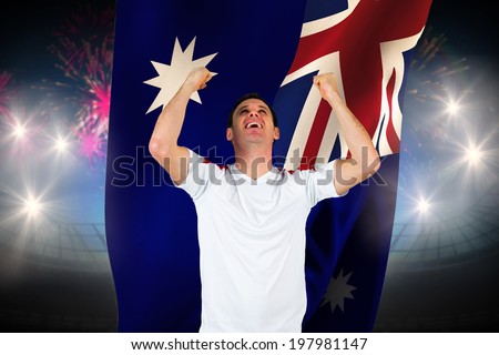 Cheering football fan in white against fireworks exploding over football stadium and australia flag