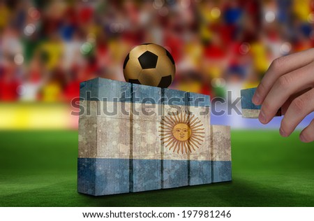 Hand building wall of argentina flag in grunge effect