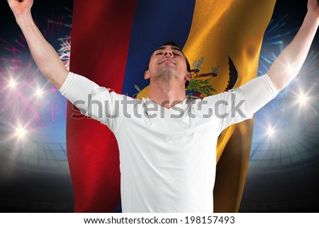 Excited football fan cheering against fireworks exploding over football stadium and ecuador flag