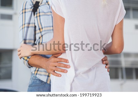 Stylish young couple hugging each other on a sunny day in the city