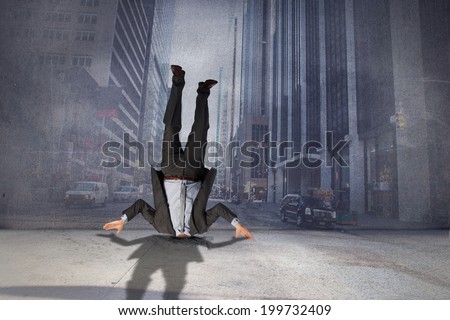 Businessman burying his head against urban projection on wall