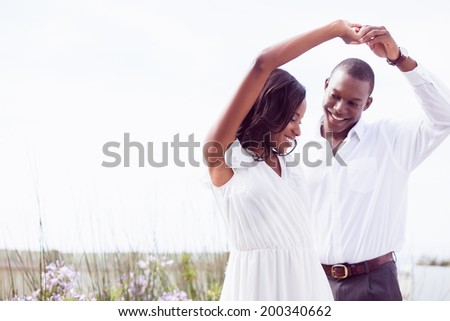 Romantic couple dancing and smiling outside in the garden