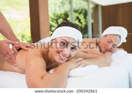 Pretty friends getting massages together in the health spa