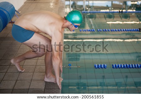 Fit swimmer ready to dive into the pool at the leisure center